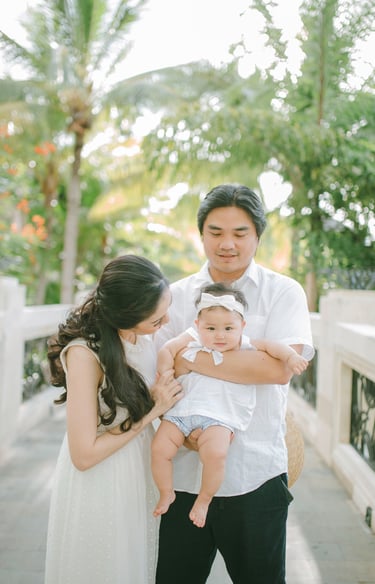 Mother holding baby in close moment during family photography session at Sofitel Nusa Dua Bali