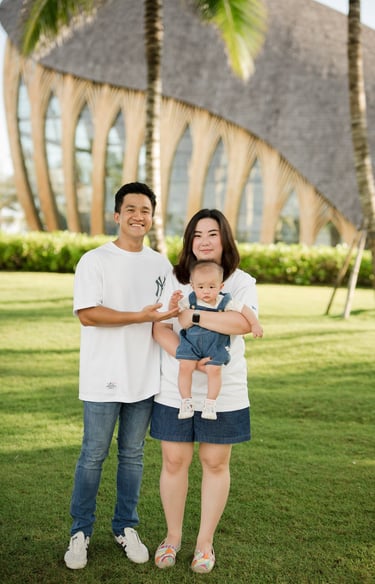 Family portrait standing together on the lawn at The Apurva Kempinski Nusa Dua Bali