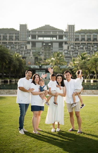 Family portrait with The Apurva Kempinski resort building in the background in Nusa Dua Bali