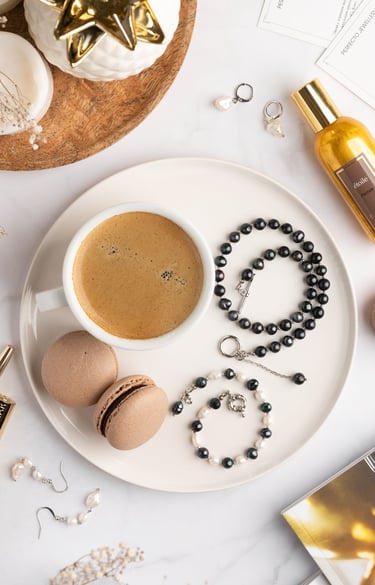 a cup of coffee and a rosary on a plate
