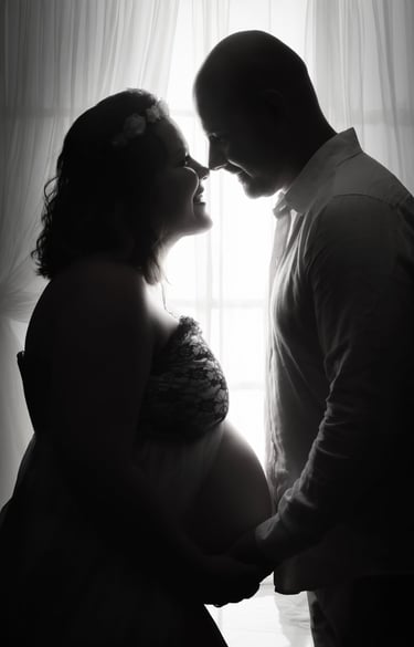 a pregnant woman and her husband are shown in this black and white photo