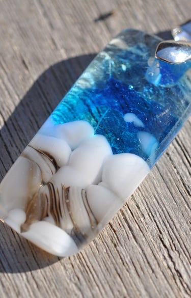 a blue and white glass pendant