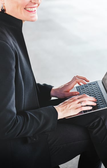 Modern businesswoman typing on a laptop