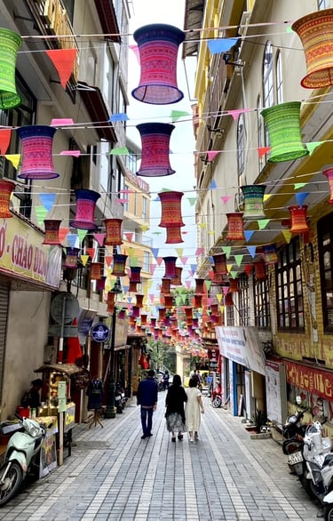 a couple of people walking down a street
