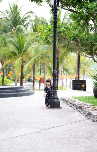 Child walking near tropical palms at JW Marriott Phu Quoc
