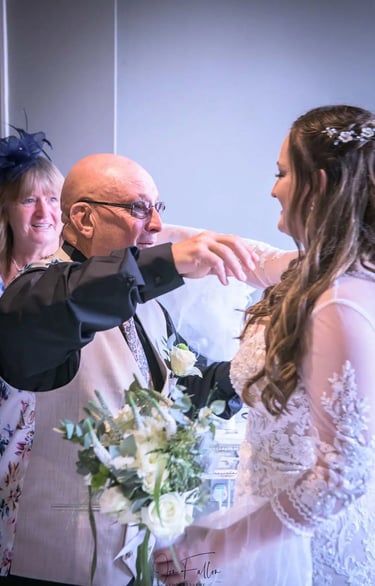 A proud father hugs his daughter during an emotional bridal reveal.