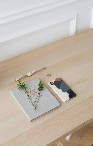 a phone phone with a plant in a vase on a table