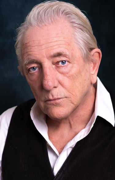a man with a white shirt and black vest