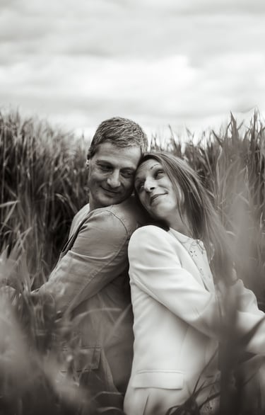 a man and woman are hugging in a field