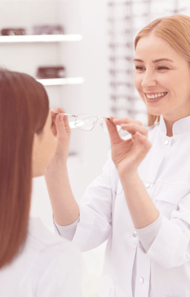 a woman in a white lab coat is looking at a woman in a white lab