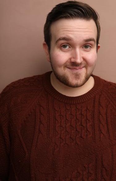 Cade MacFee actor headshot on a blush background