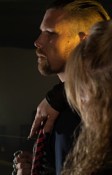 a man with a beard and a woman with a red tie