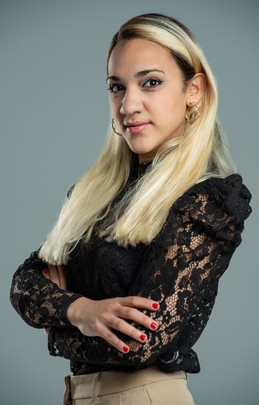 a woman with blonde hair and a black top