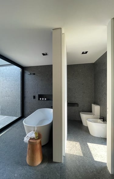 a bathroom with a tub and a tub in the middle of the room