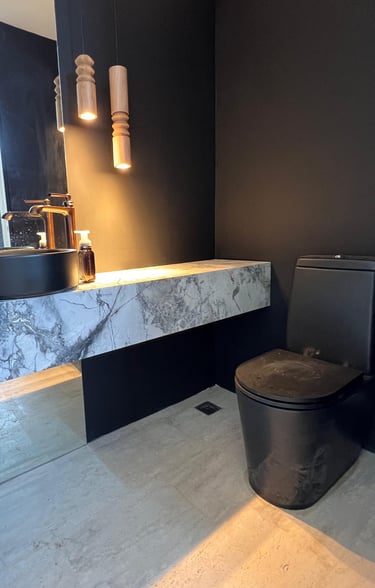 a toilet with a black toilet and a sink