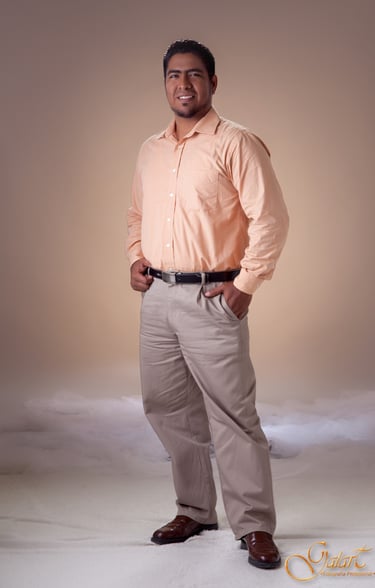 a man in a pink shirt and tan pants