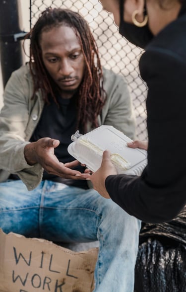 woman handing man a container of food