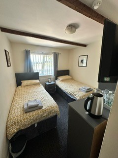 a bedroom with two beds and a coffee maker