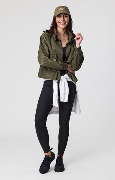 Fashion e-commerce photography - a woman in a green jacket and black leggings