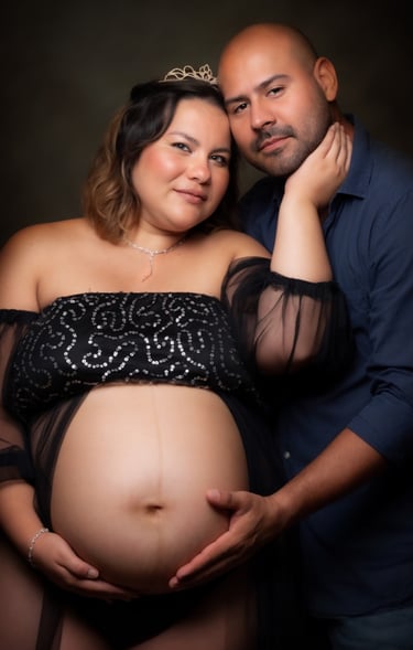 a pregnant woman and her husband are posing for a photo