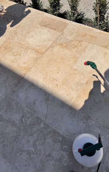 applying penetrating sealer to travertine tiled floor