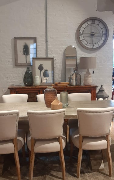 a dining room table with a clock on the wall