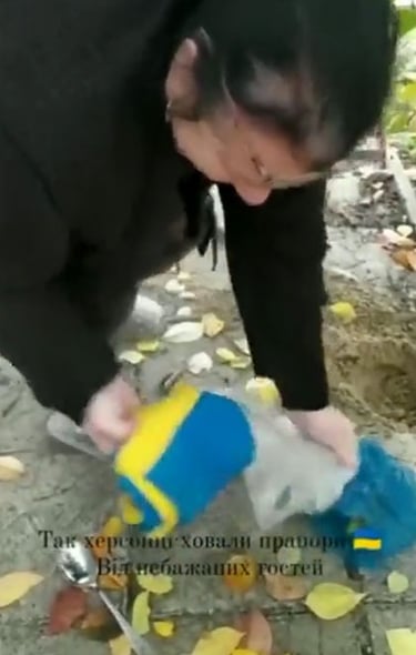 Woman retrieving her flag after liberation