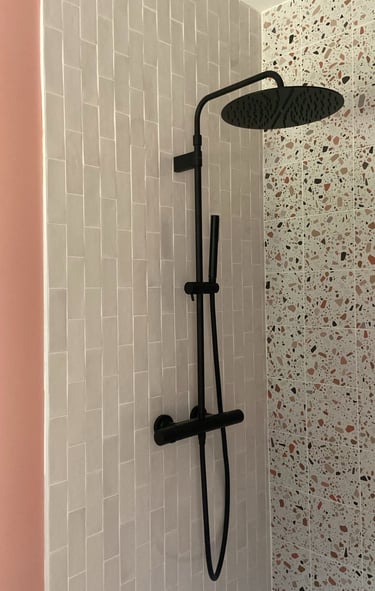 a shower with a shower head and a shower head
