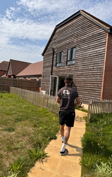 man carrying boxes into a home
