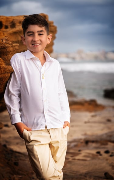 a boy in a white shirt and tan pants