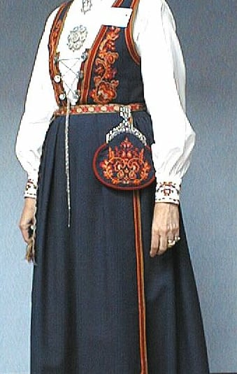 A woman in a blue bunad with red detailing