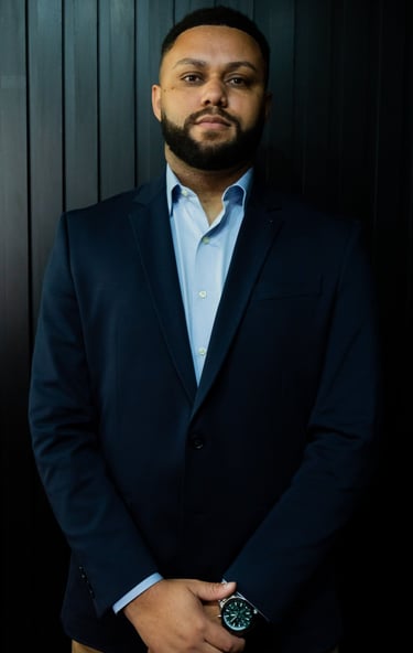a man in a suit and a watch on a black background