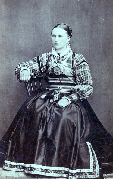 A black and white image circa 1890s of a woman in traditional dress