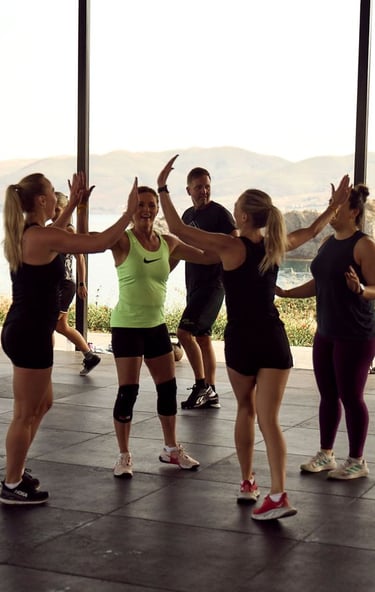 a fitness group giving high-fives at the end of a workout
