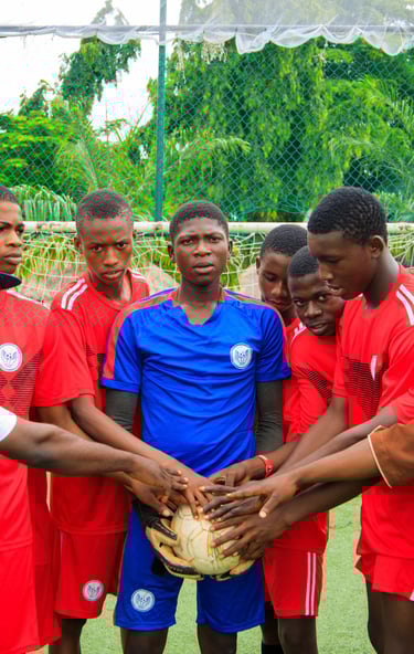 a group of men standing around a soccer ball