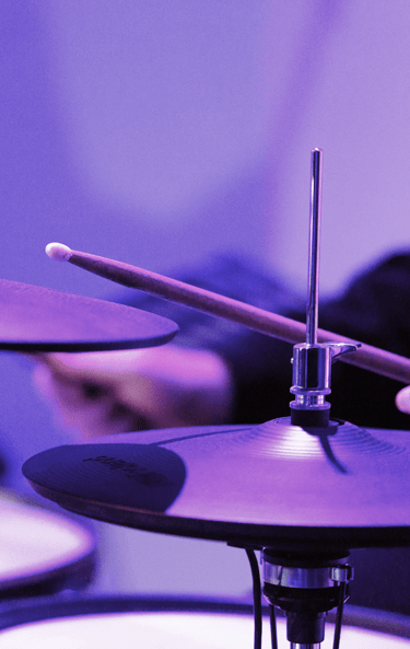 Purple lighting with up close drums
