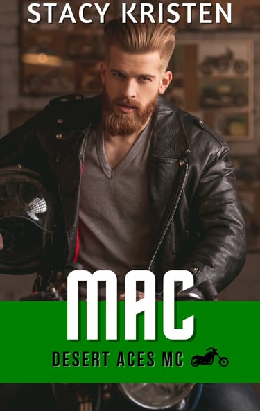 A man with a beard sitting astride a motorcycle, wearing a leather jacket, holding a helmet.