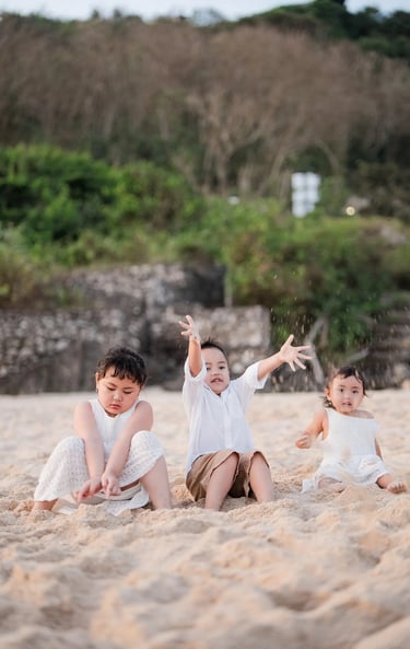 Playful candid moment of Ilham family children during a relaxed beach family photography session in Bali