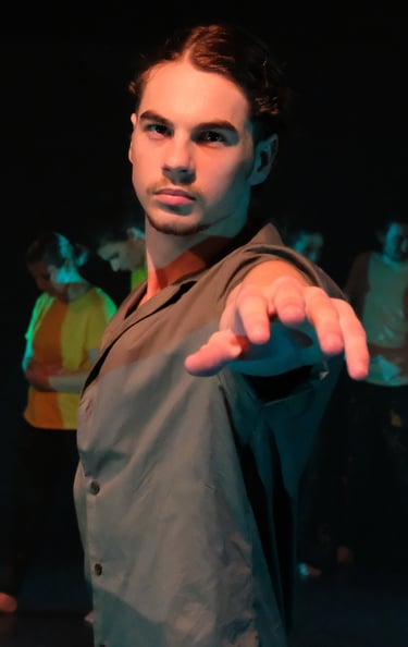 a man in a suit and tie is pointing at the camera