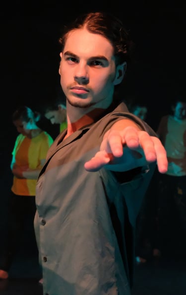 a man in a suit and tie is pointing at the camera