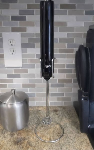 Handheld electric instawhisk milk frother on a kitchen counter