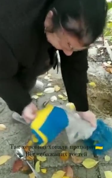 Woman retrieving her flag after liberation