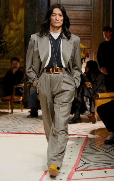 Versace Spring Summer 2026 – Grey pinstripe suit with gold accessories.