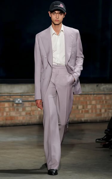 Aaron Esh lilac tailored suit with cap on runway at London Fashion Week 2026.