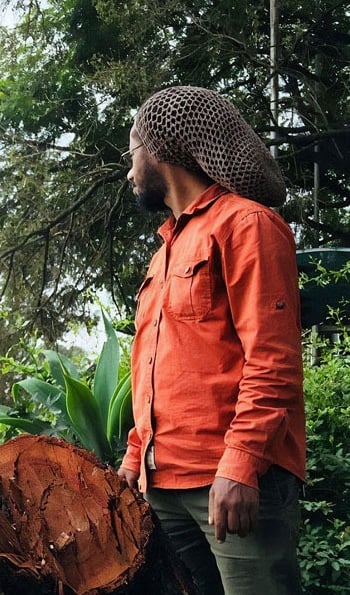 a man in a hat on a tree stump