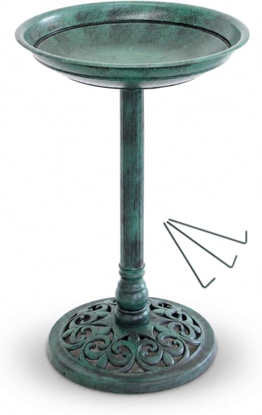 Antique green pedestal bird bath with decorative filigree base and ground stakes for garden decor.