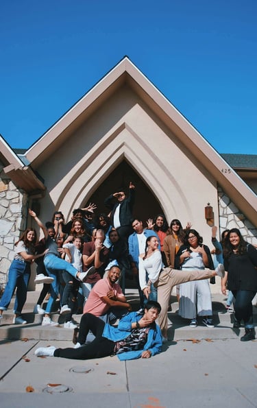 a group of people standing around a man in a suit and tie