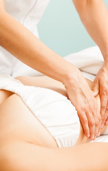 a woman is getting a massage at a spa