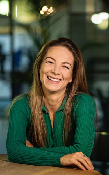 a woman in a green shirt smiling