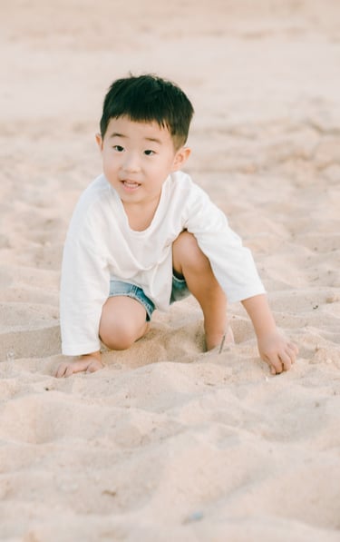 Child beach portrait during a luxury family photography session at The Apurva Kempinski Bali.